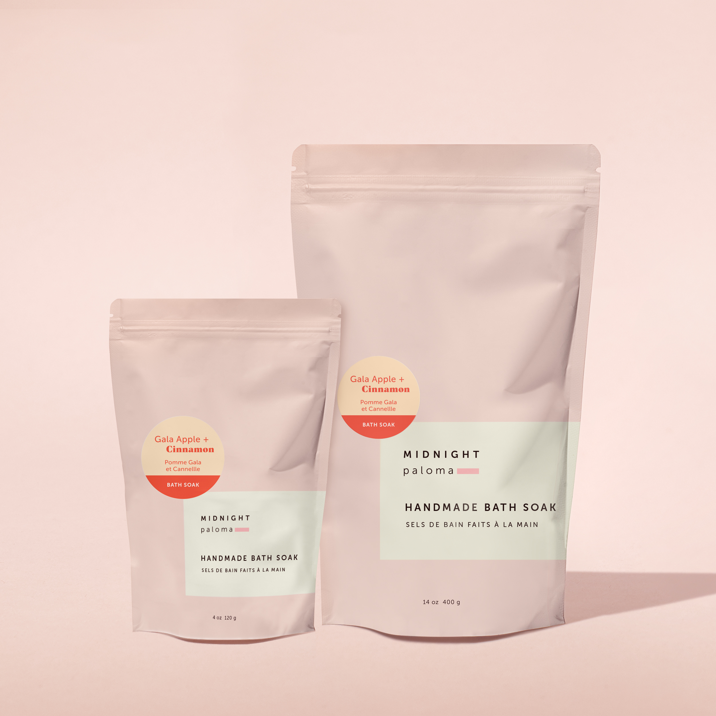Midnight Paloma’s Gala Apple + Cinnamon Bath Soak pouches in 4 oz and 14 oz sizes, with soft peach scent stickers. Designed by Danielle Gracioso.